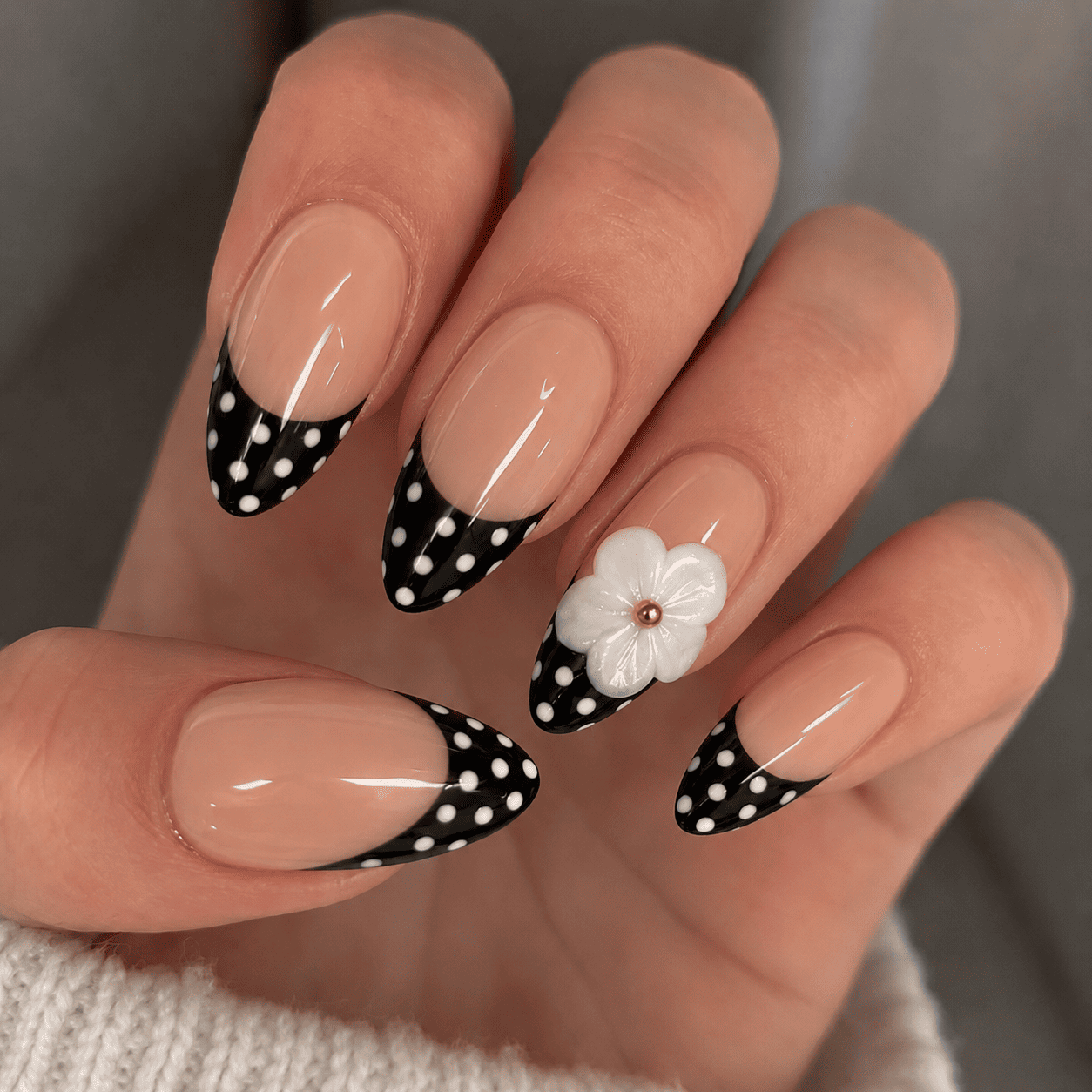 Fine Nails Iconic – Schwarz-Weißes Design mit floralen Akzenten, an der Hand getragen